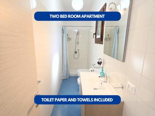 two bed room apartment with a bathroom with a sink and a mirror at Dammuso - Cala Cinque Denti - AFFITTICA in Pantelleria