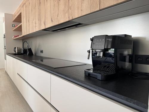 a kitchen with a espresso machine on a counter at Vakantiewoning The View in Gooik