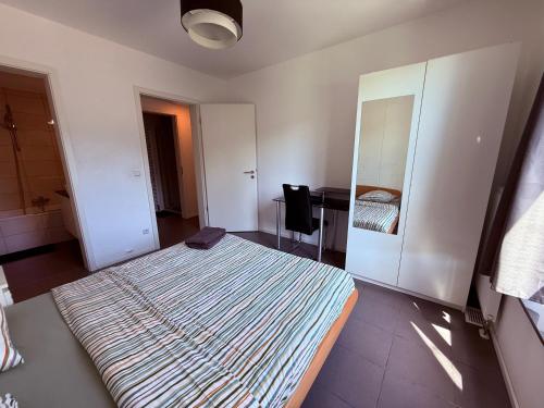 a bedroom with a large bed and a desk at Lovely 3 bedroom apartment in central Esch Alzette in Esch-sur-Alzette