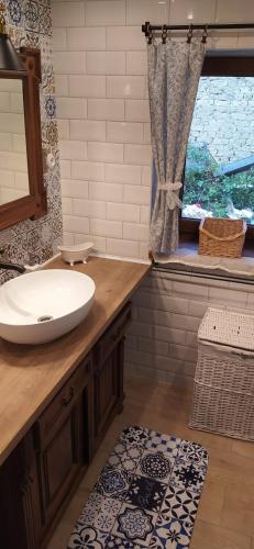 a bathroom with a sink and a window at Chalupa u Holoubků in Hrubá Vrbka