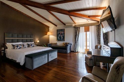 a bedroom with a bed and a living room at Agriturismo Villa Godenano - Pool&Restaurant in Castellina in Chianti
