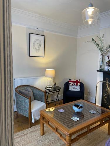 a living room with a coffee table and a chair at River walk . Shrewsbury.Shropshire.With parking. in Shrewsbury
