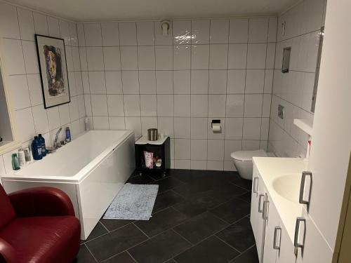 a bathroom with a tub and a sink and a toilet at Svolvær - Jektveien 20 in Svolvær