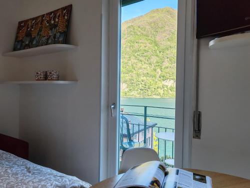 a bedroom with a door open to a balcony at Hotel Bersagliere in Laglio