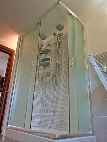 a shower with four shower heads in a bathroom at Villa Panorama Pool & Garden in Trevignano Romano