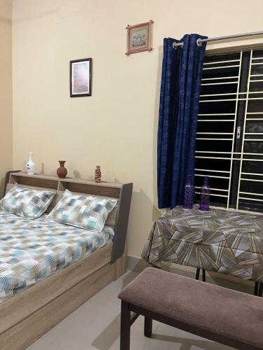 a bedroom with a bed and a window at GoodLyfe Homes in Bhubaneshwar