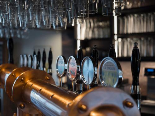a row of mirrors on a bar with bottles at Il Viaggio Impresa Sociale in Bicchignano