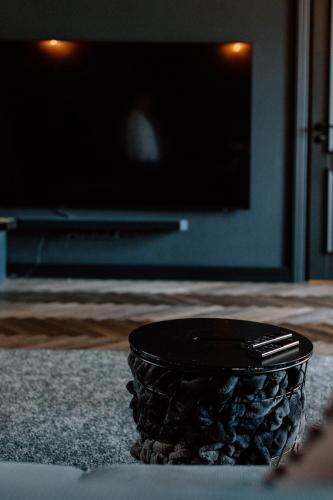 a black bowl sitting on a table in a living room at Black Princess in Cēsis