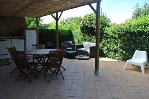 a patio with a table and chairs and a couch at Les rives de St Tropez in Saint-Tropez