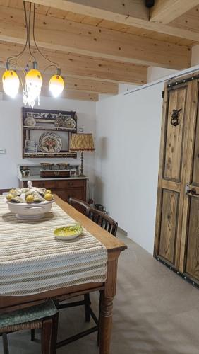 a kitchen with a table with a bowl of fruit on it at Le Mennule 26 in Alliste
