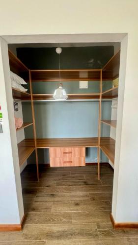 an empty closet with wooden shelves in a room at Villa J&J Private pool near beach in Albion