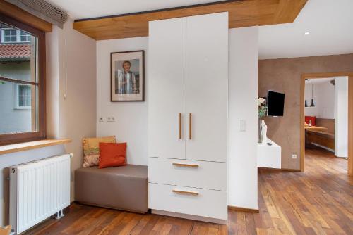 a living room with white cabinets and a couch at Obst- und Ferienhof Lehle in Immenstaad am Bodensee