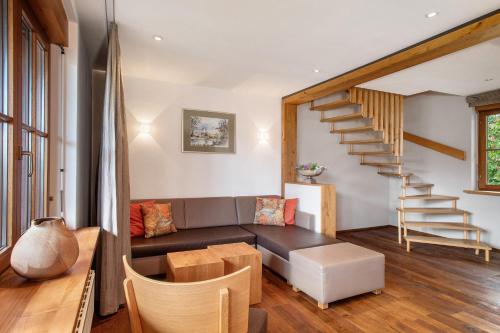 a living room with a couch and a staircase at Obst- und Ferienhof Lehle in Immenstaad am Bodensee
