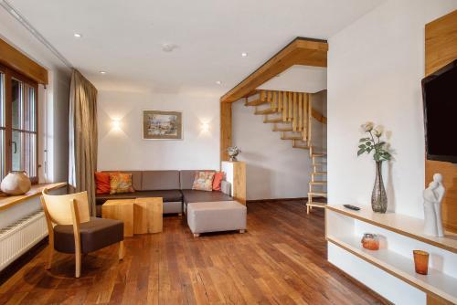 a living room with a couch and a staircase at Obst- und Ferienhof Lehle in Immenstaad am Bodensee