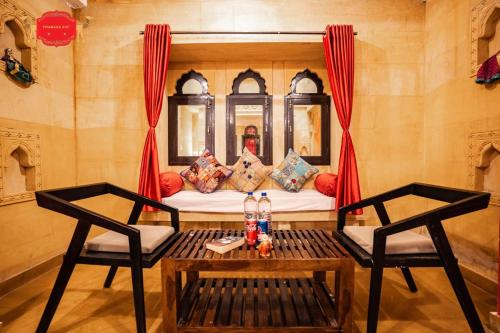 a room with a couch and two chairs and a table at Hotel Golden Legacy - by PRAMANA EXP in Jaisalmer