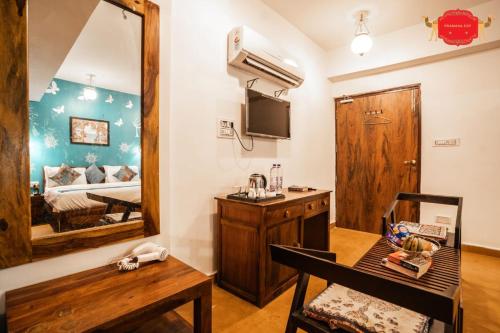 a room with a bedroom with a bed and a mirror at Hotel Golden Legacy - by PRAMANA EXP in Jaisalmer
