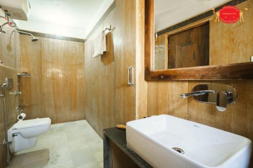 a bathroom with a sink and a toilet and a mirror at Hotel Golden Legacy - by PRAMANA EXP in Jaisalmer