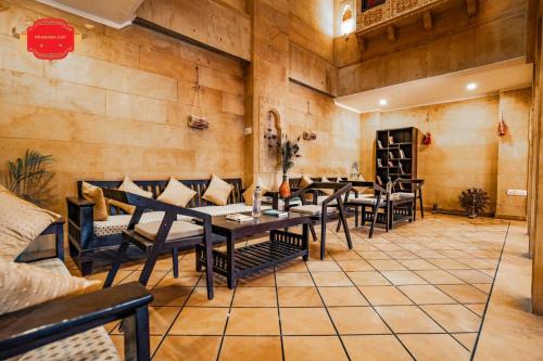 a restaurant with wooden walls and tables and chairs at Hotel Golden Legacy - by PRAMANA EXP in Jaisalmer