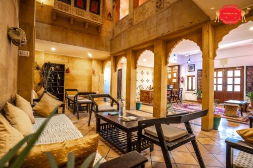a large living room with couches and tables at Hotel Golden Legacy - by PRAMANA EXP in Jaisalmer