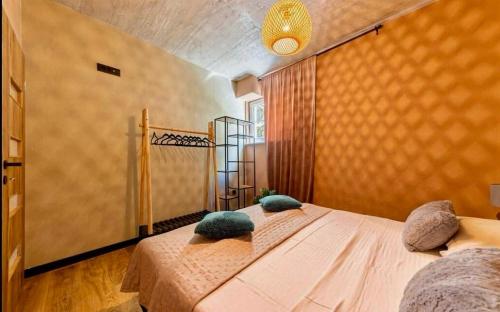 a bedroom with a bed with two pillows on it at Luxury Apartments with Private Pool and Sauna or with jacuzzi near Split , Sea View in Podstrana