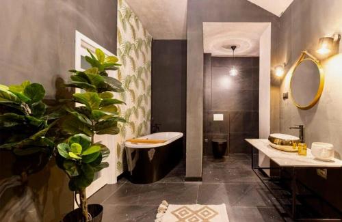a bathroom with a sink and a tub and a toilet at Luxury Apartments with Private Pool and Sauna or with jacuzzi near Split , Sea View in Podstrana