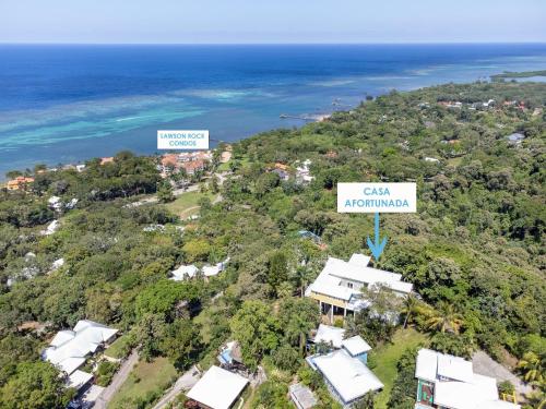 an aerial view of a house and the ocean at Casa Afortunada home in Roatan