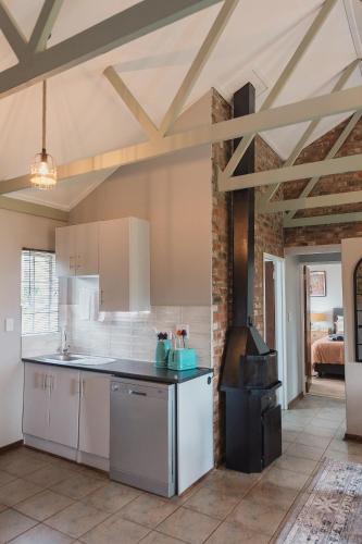 a kitchen with white cabinets and a stove at Welverdiend in Bloemfontein