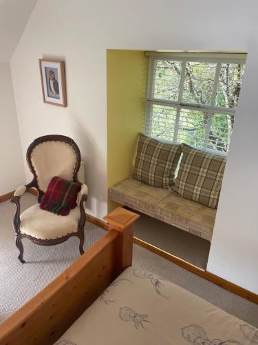 a room with a couch and a chair and a window at The Steading at Barmore in Tarbert