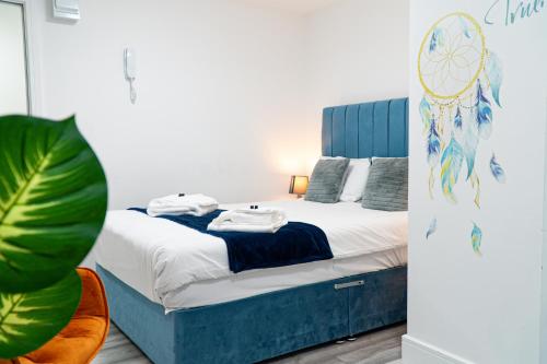 a bedroom with a bed with towels on it at Centrally Located Apartments in Cardiff