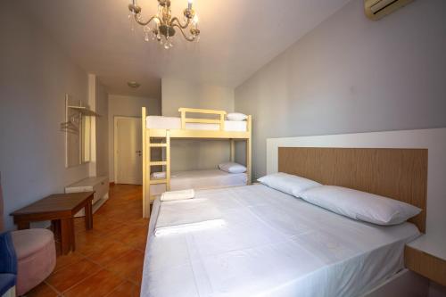 a bedroom with a bunk bed and a desk at Hotel Ramses Ks in Golem