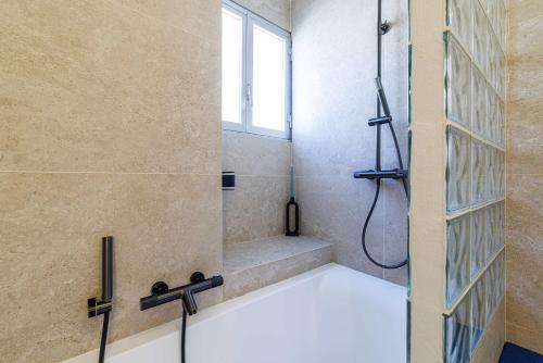 a bathroom with a shower with a window at Emilie - panoramic sea views beach facing paradise in Vallauris