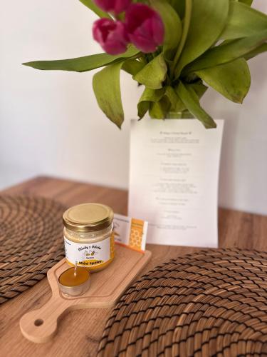 a jar of honey next to a vase with flowers at Forest Mood in Wieck