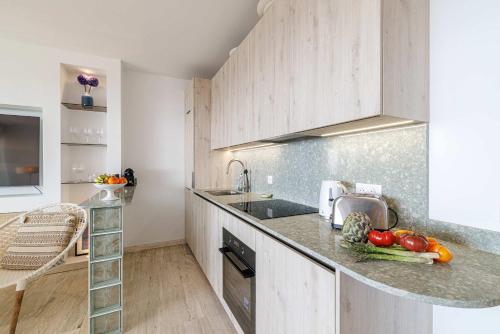 a kitchen with a counter with vegetables on it at Emilie - panoramic sea views beach facing paradise in Vallauris