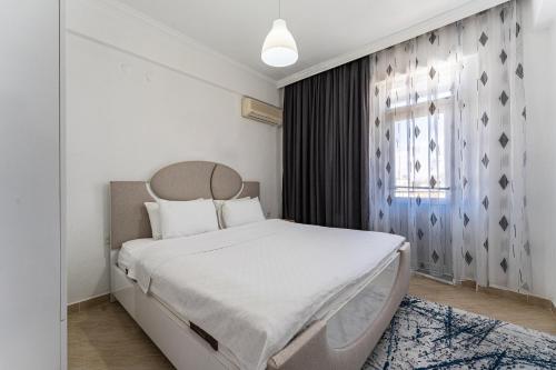 Ένα ή περισσότερα κρεβάτια σε δωμάτιο στο ASSOS APART BELEK