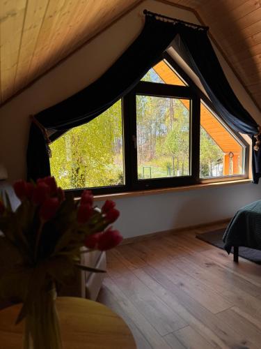 a room with a large window with a vase of flowers at Forest Mood in Wieck