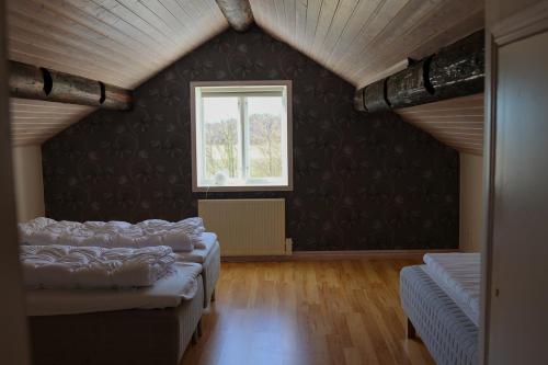 a room with four beds and a window at Countryside house with sauna in Enhörna