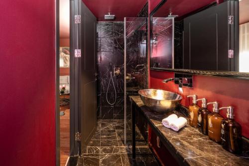 a bathroom with a counter with a sink and a shower at Casa Suzanna Hotel Tel-Aviv קאסה סוזנה נחלת בנימין in Tel Aviv
