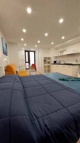 a large bedroom with a large blue blanket on the bed at Casa Nina in Amalfi