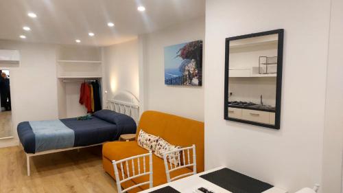 a small room with a bed and a mirror at Casa Nina in Amalfi