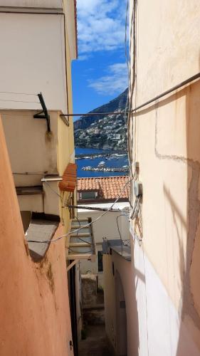an alley between two buildings with a view of the ocean at Casa Nina in Amalfi