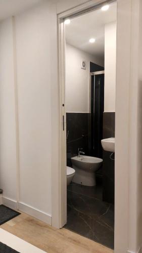 a bathroom with a white toilet and a sink at Casa Nina in Amalfi