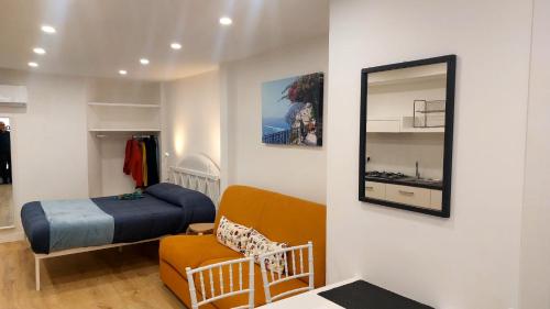 a small bedroom with a bed and a mirror at Casa Nina in Amalfi