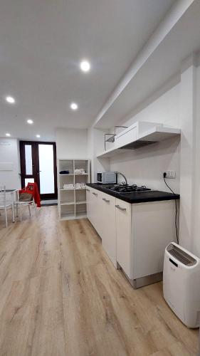a kitchen with white cabinets and a counter top at Casa Nina in Amalfi