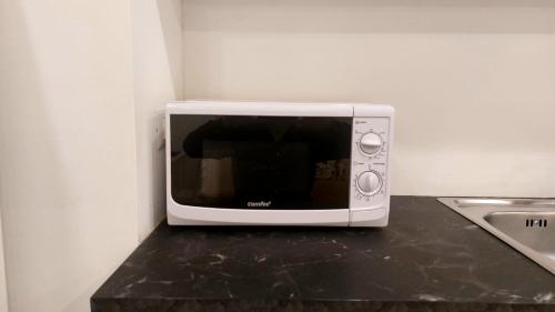 a white microwave sitting on top of a counter at Casa Nina in Amalfi