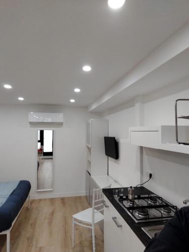 a white kitchen with a stove and a couch at Casa Nina in Amalfi