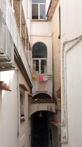 an alley way with a building with stairs and a window at Casa Nina in Amalfi