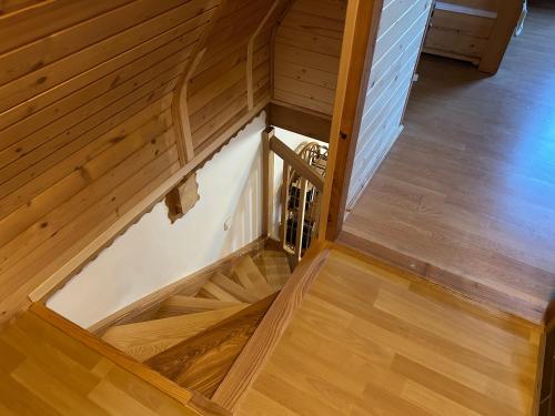 an overhead view of a wooden staircase with wood floors at Dom wakacyjny Podlas in Żywiec