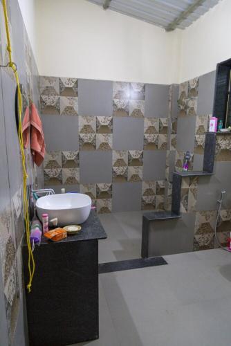 a bathroom with a sink on a counter in a room at Bapunchi Wadi, beach-house in Alibaug