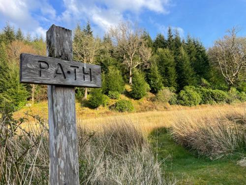 a wooden sign that says path on a wooden pole at The Steading at Barmore in Tarbert
