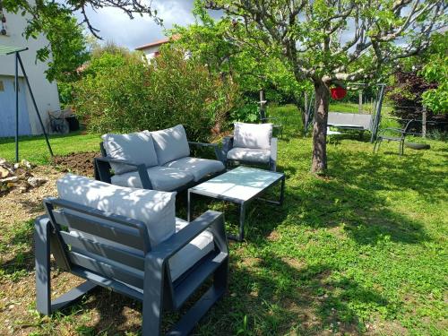 a group of chairs and a table in a yard at Maison avec jardin in Montpezat-de-Quercy
